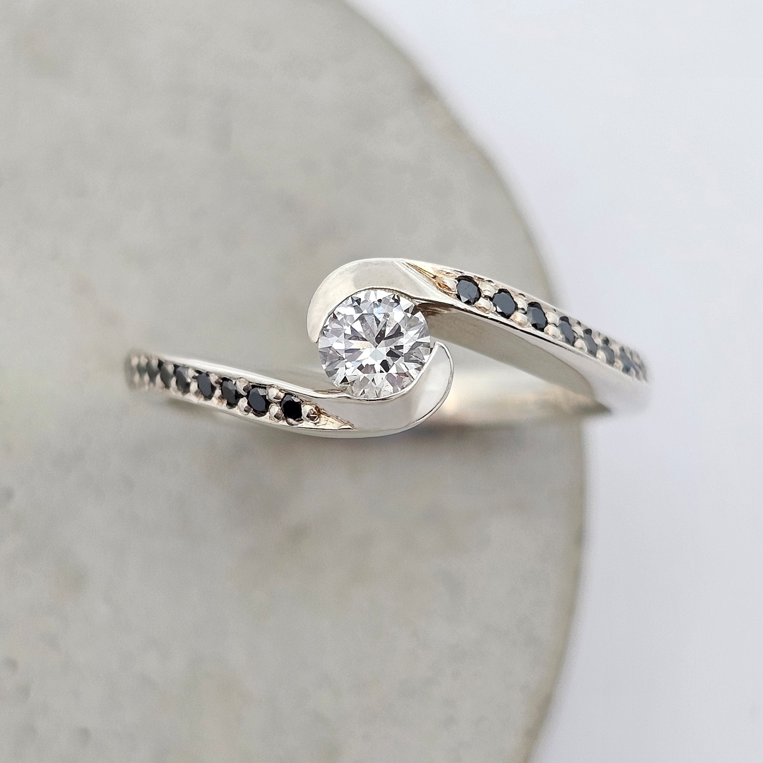 9ct white gold semi rub-set round white diamond ring with black diamond shoulder stones