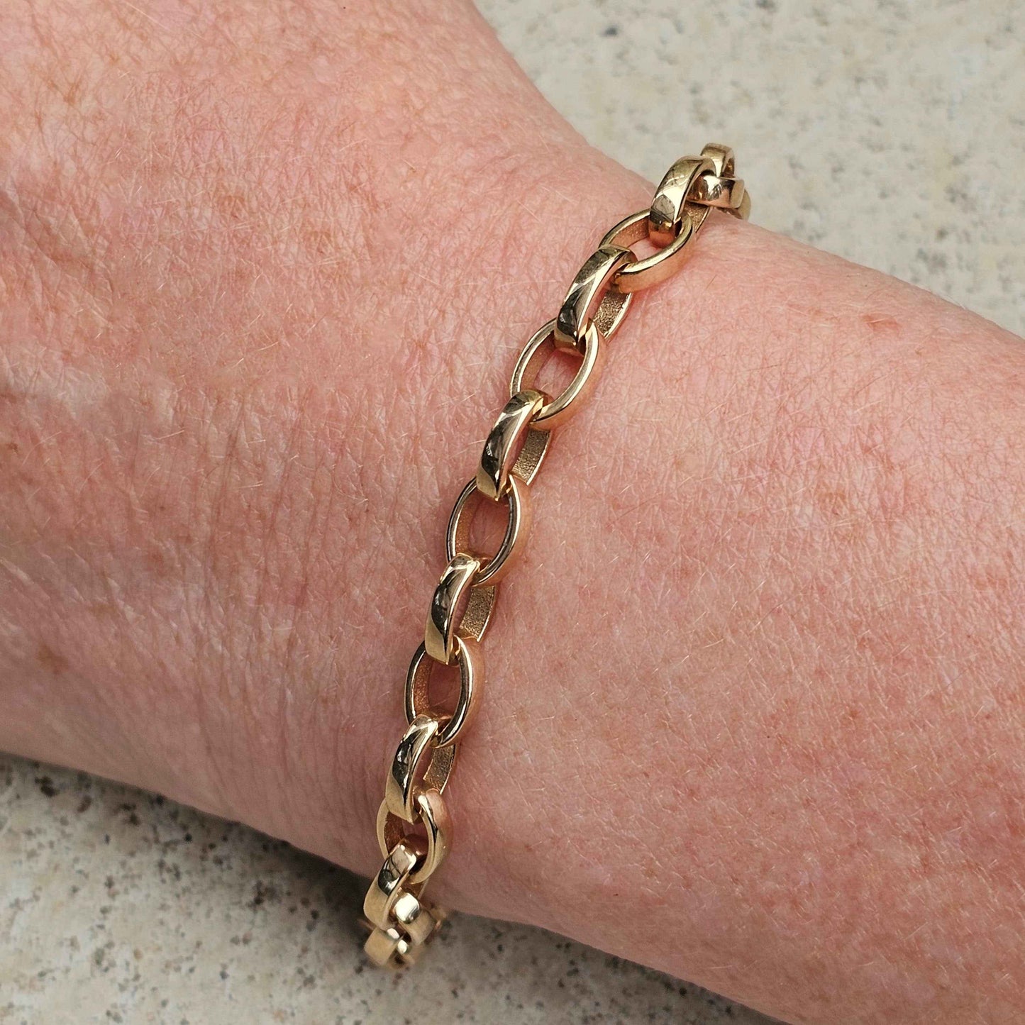 yellow gold oval heavy link belcher bracelet on wrist
