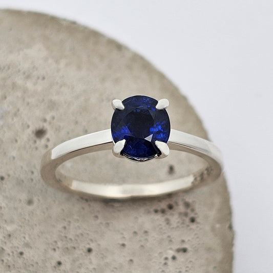 9ct white gold ladies engagement ring with a four claw set fine blue oval sapphire.