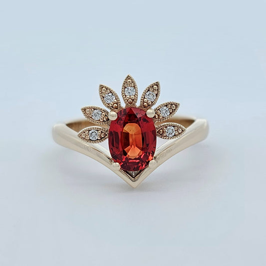 9ct yellow gold ladies coloured gemstone ring with  claw set oval orange sapphire and a fan of brilliant white round diamonds.