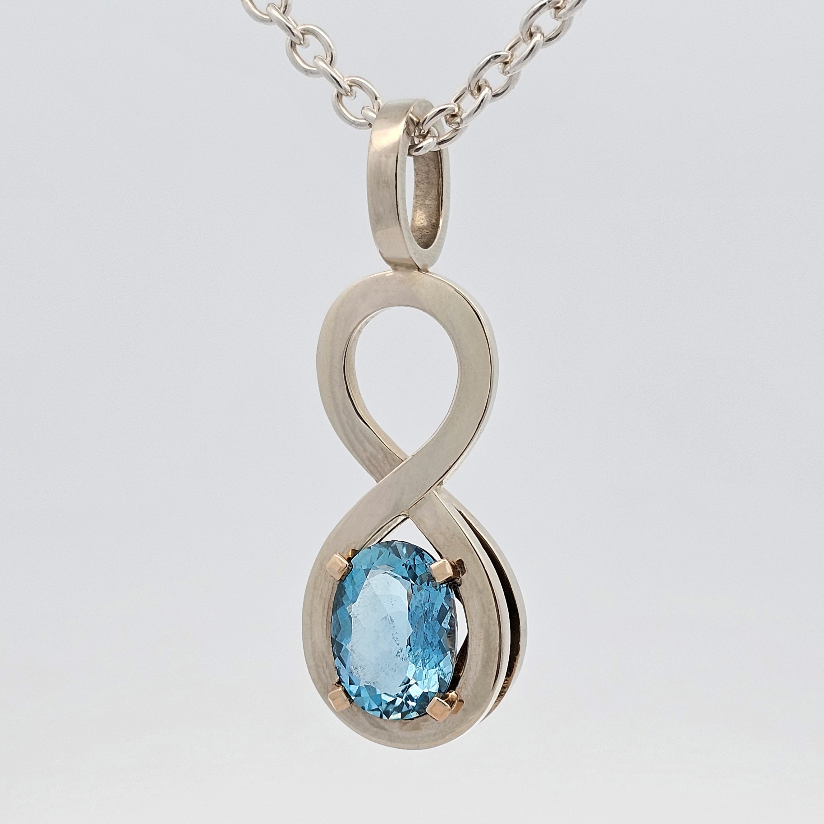 white gold unique infinity aquamarine claw-set pendant