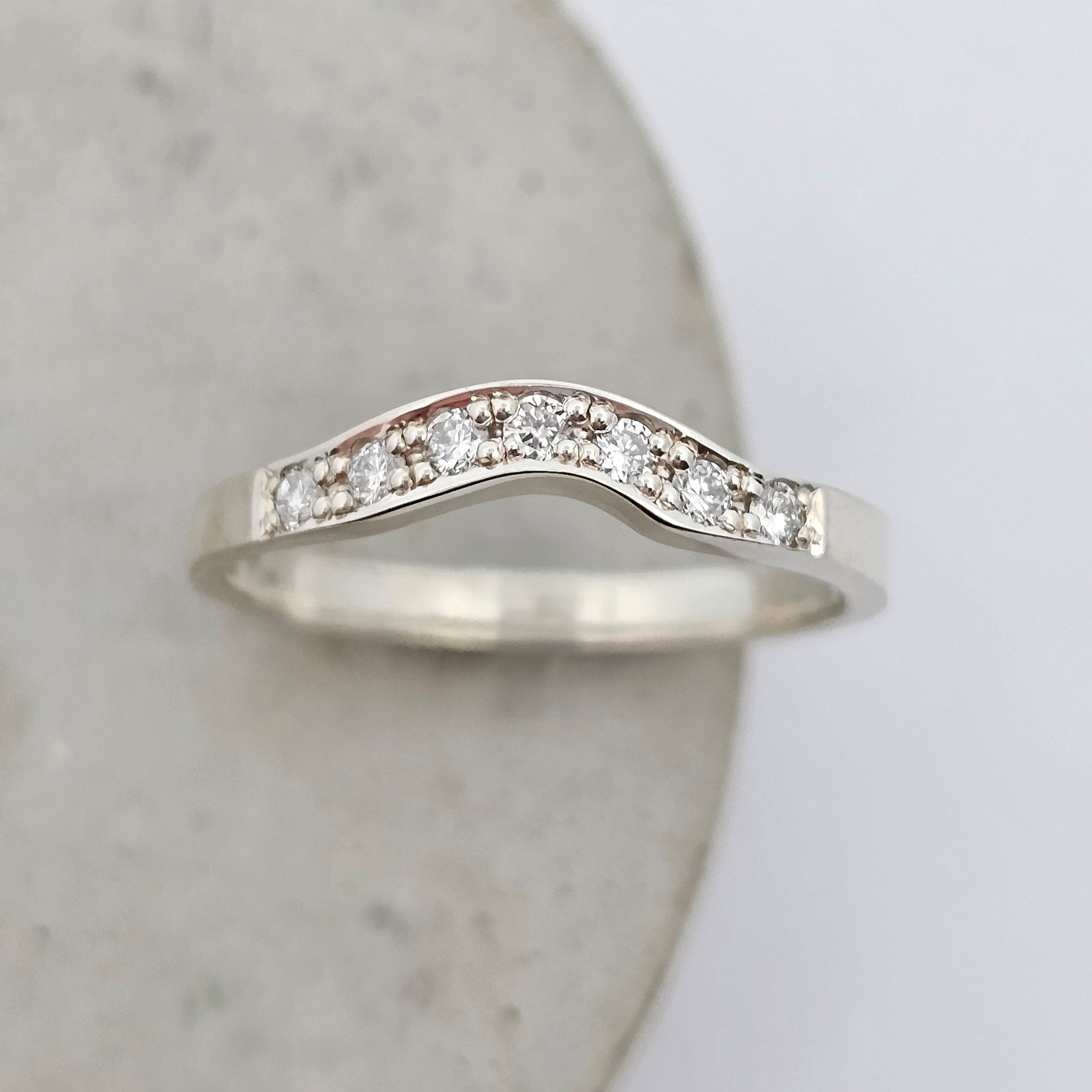 white gold curved shaped fitted diamond set ladies wedding ring 