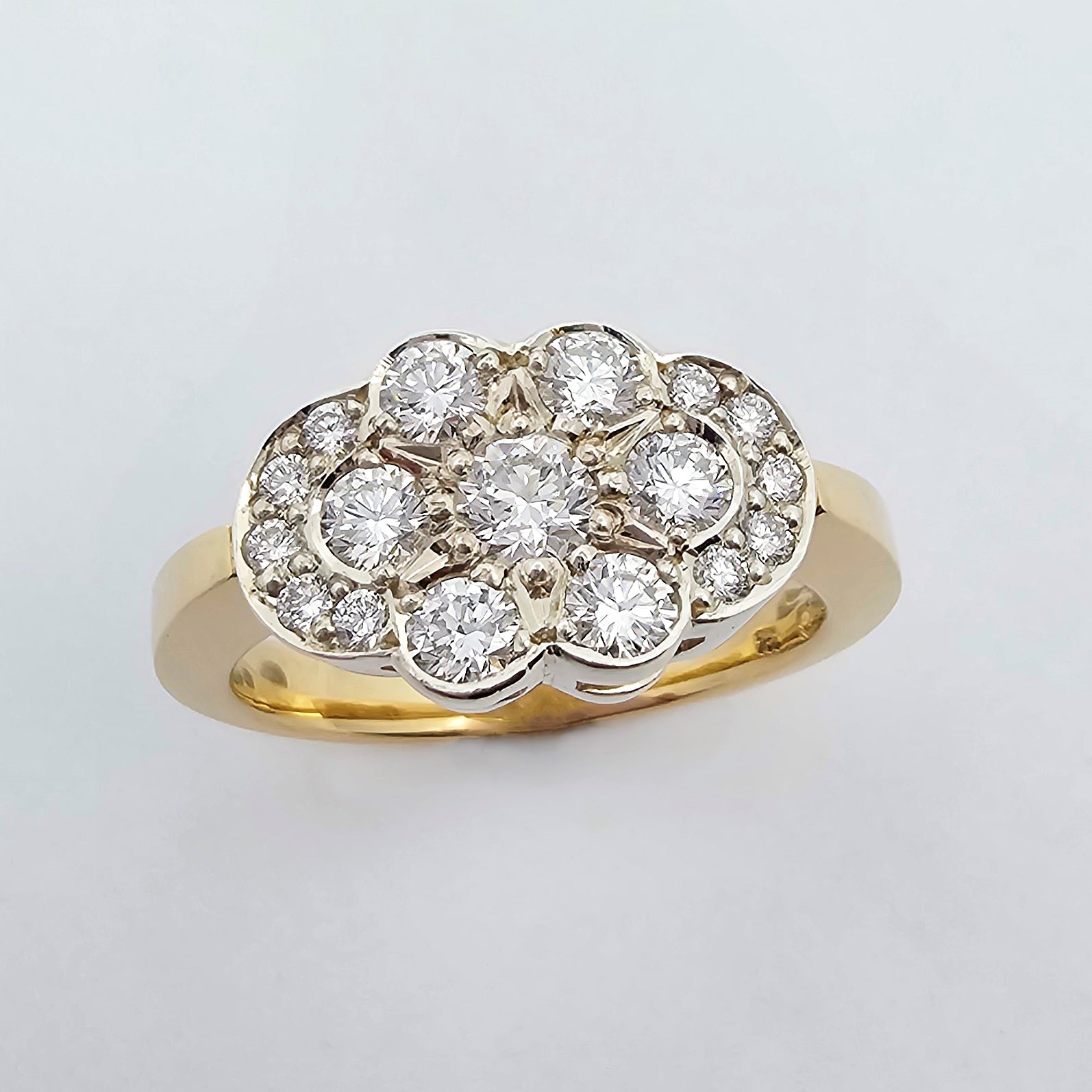 9ct yellow and white gold cluster ring featuring a star burst pattern of textural bead set brilliant round diamonds held by a solid gold band.