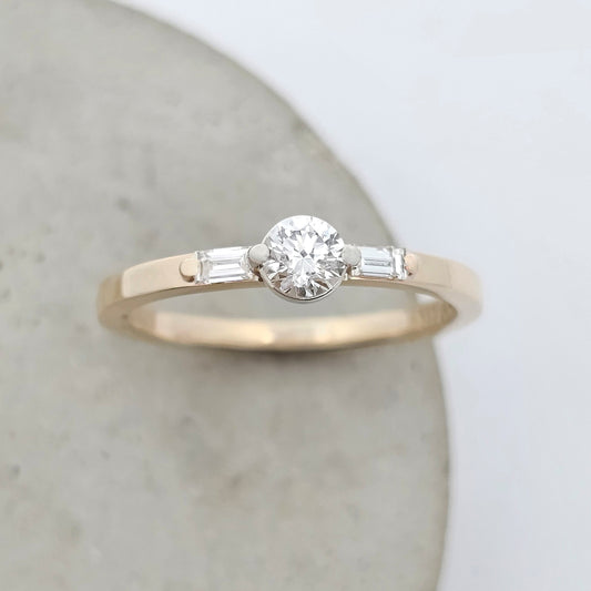 diamond ring; natural diamond ring; diamond stacker ring; trilogy diamond ring; yellow gold ring; yellow gold diamond ring; natural diamond stacker ring; dainty engagement ring; dainty diamond engagement ring; claw set diamond ring; baguette diamond ring; yellow gold diamond ring
