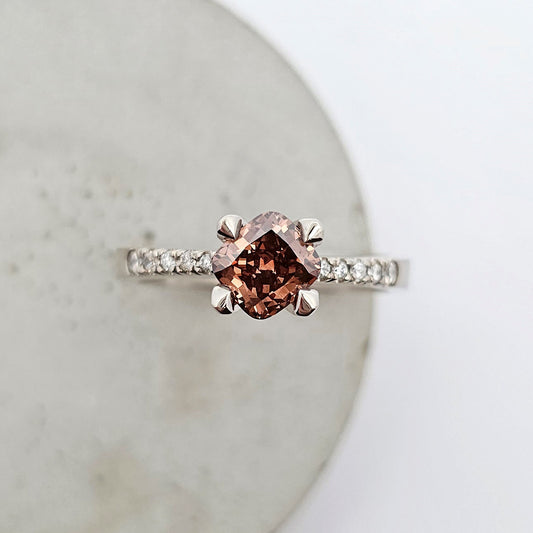 9ct white gold ladies engagement ring featuring a cushion cut deep brown Argyle Champagne diamond and bright white diamonds bead set into the shoulder.