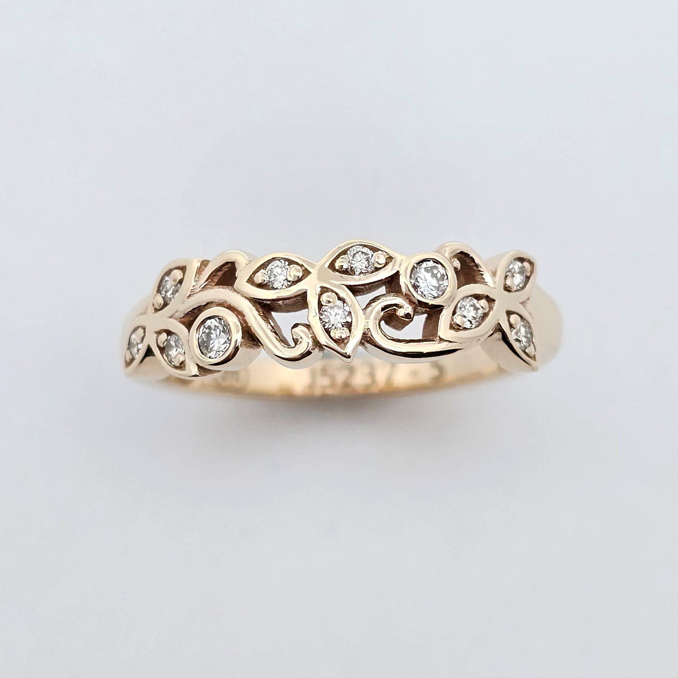 Yellow gold diamond ring with a petal-inspired design, featuring intricate openwork and white diamonds set in each petal for a delicate, nature-inspired look.