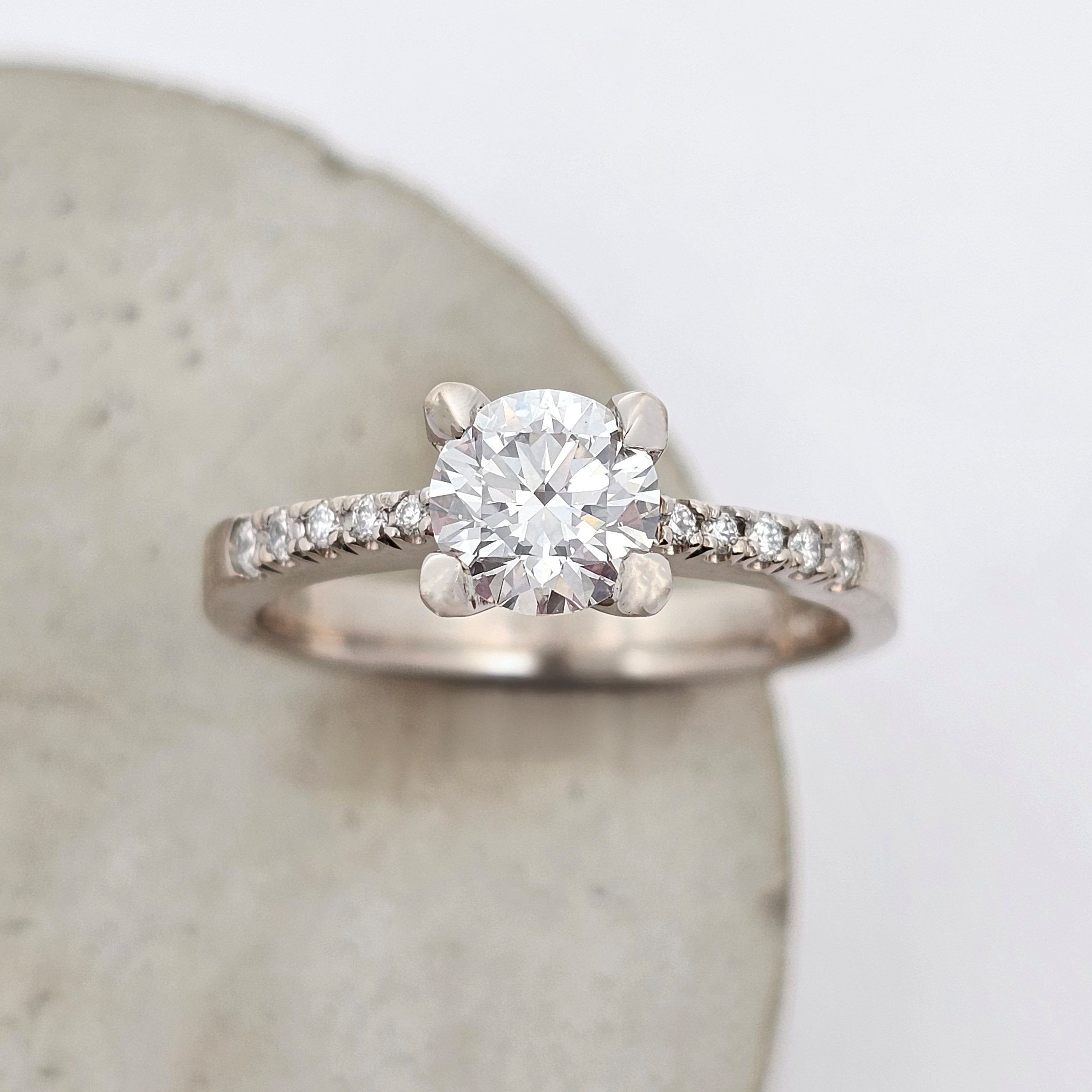 1ct natural diamond ring with graduating French-set diamond shoulders, featuring a strong, structured design and classic solitaire style.