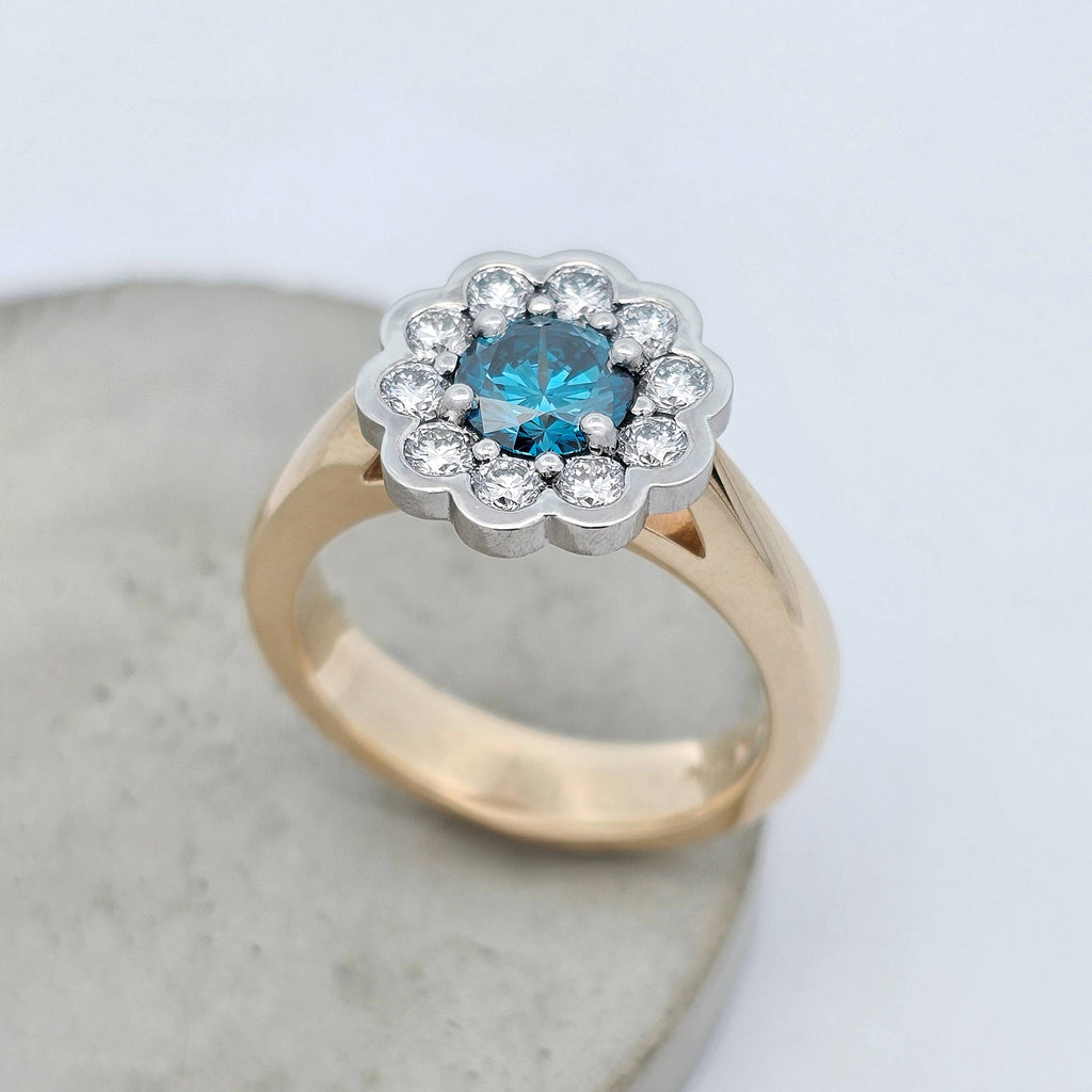 Ocean Bloom 1.005ct blue Sea Diamond ring set it platinum surrounded by natural white diamonds with a 9ct yellow gold band.