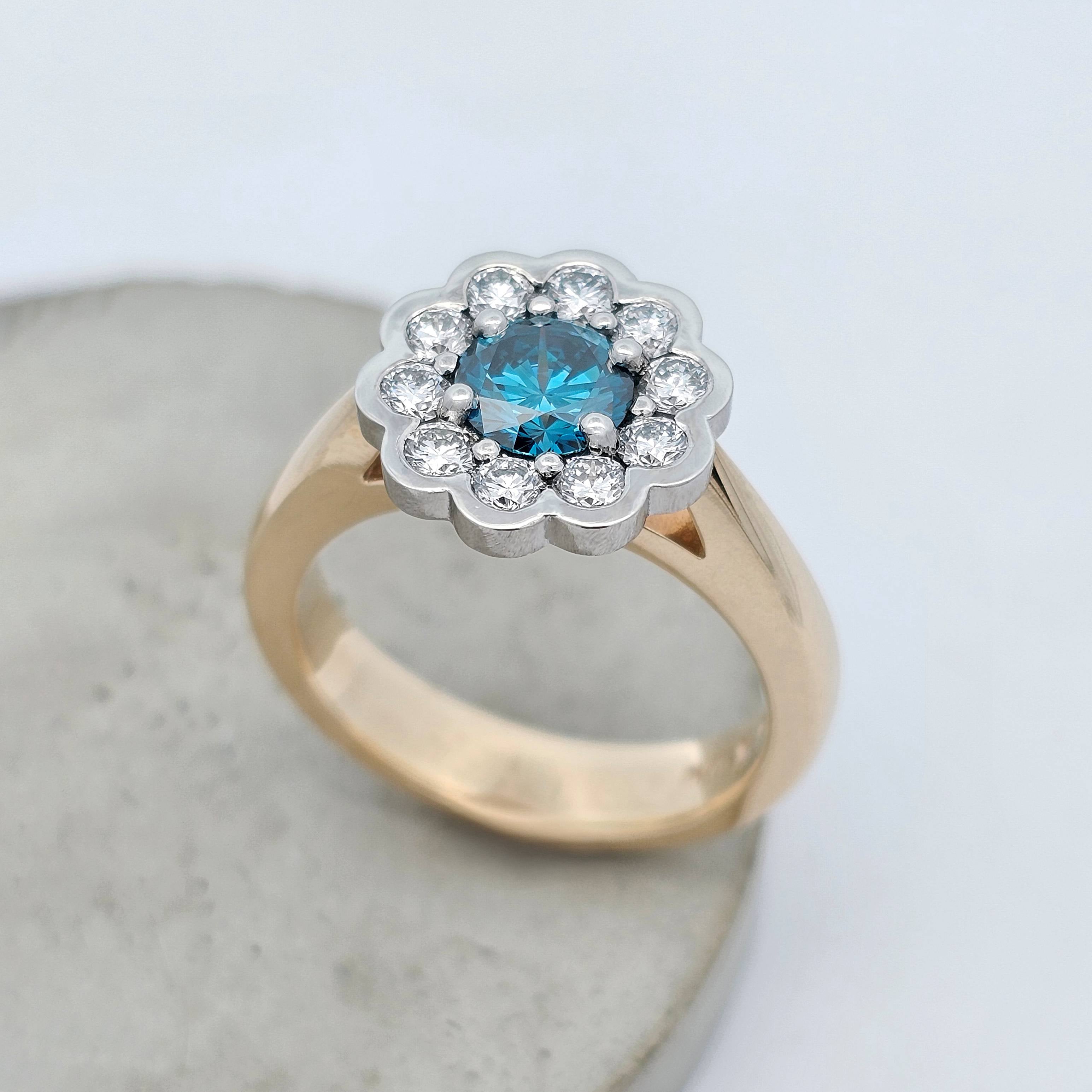 Ocean Bloom 1.005ct blue Sea Diamond ring set it platinum surrounded by natural white diamonds with a 9ct yellow gold band.