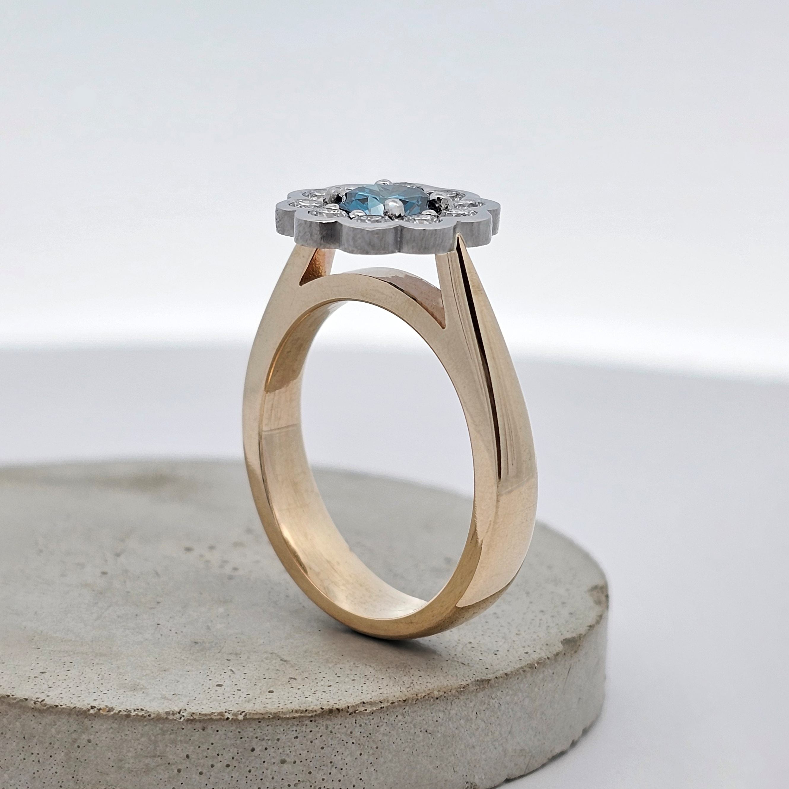 Ocean Bloom 1.005ct blue Sea Diamond ring set it platinum surrounded by natural white diamonds with a 9ct yellow gold band. Side View.