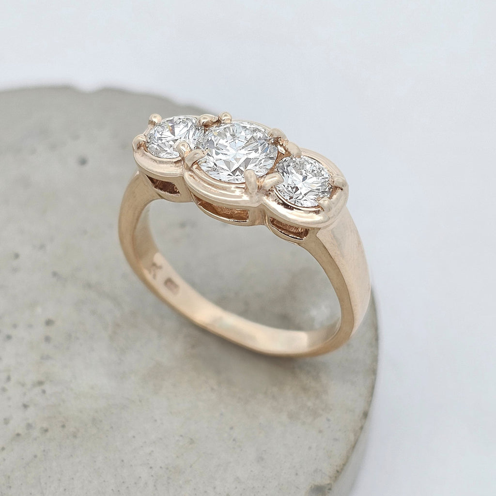 9ct yellow gold trilogy ring featuring three natural round brilliant-cut diamonds in a modern claw-set design.