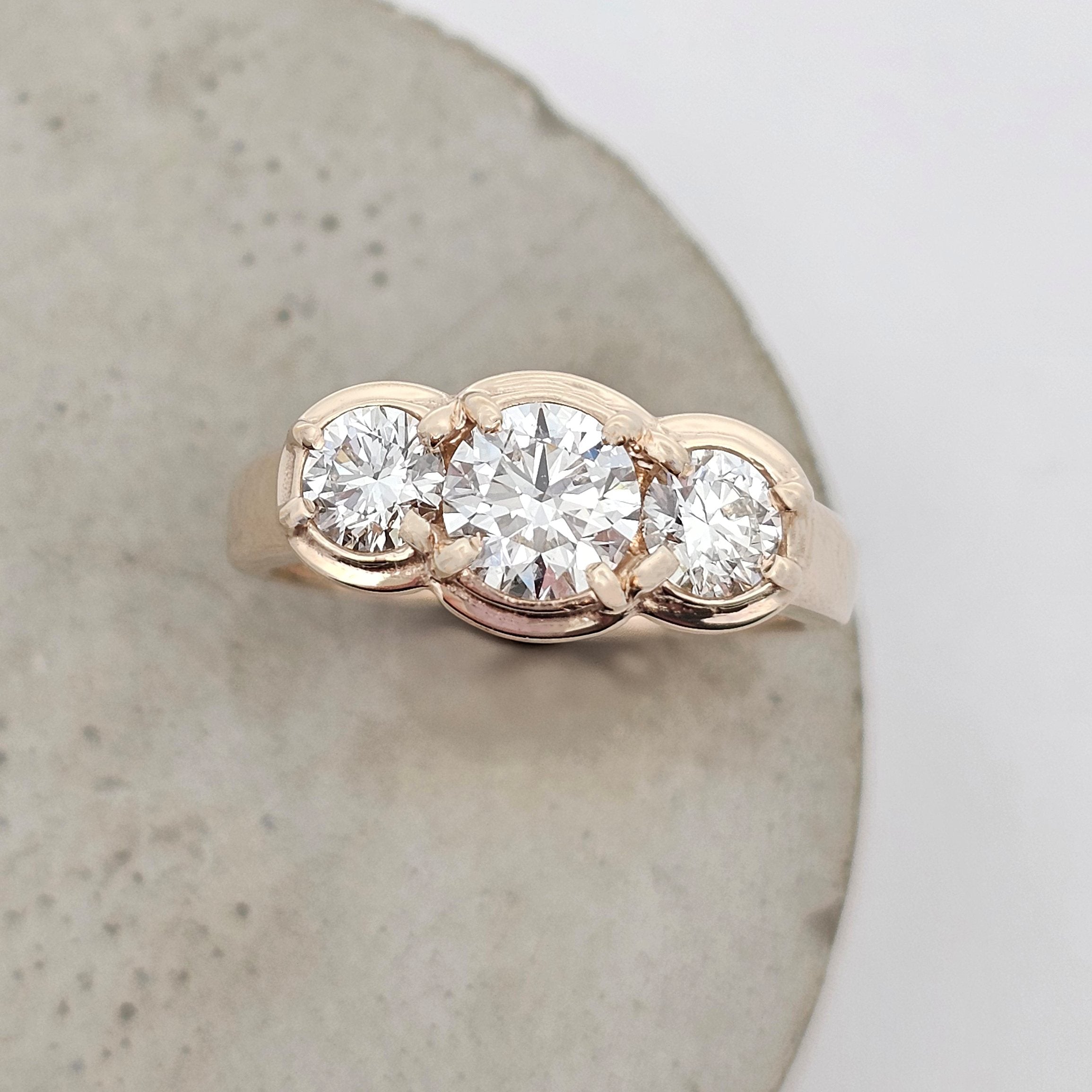 9ct yellow gold trilogy ring featuring three natural round brilliant-cut diamonds in a modern claw-set design.