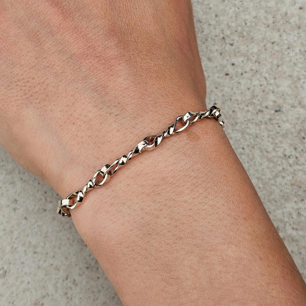 white gold twisted link handmade bracelet on wrist