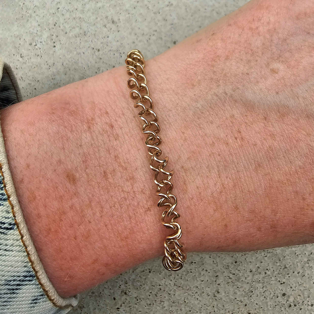 rose and white gold unique link bracelet on wrist