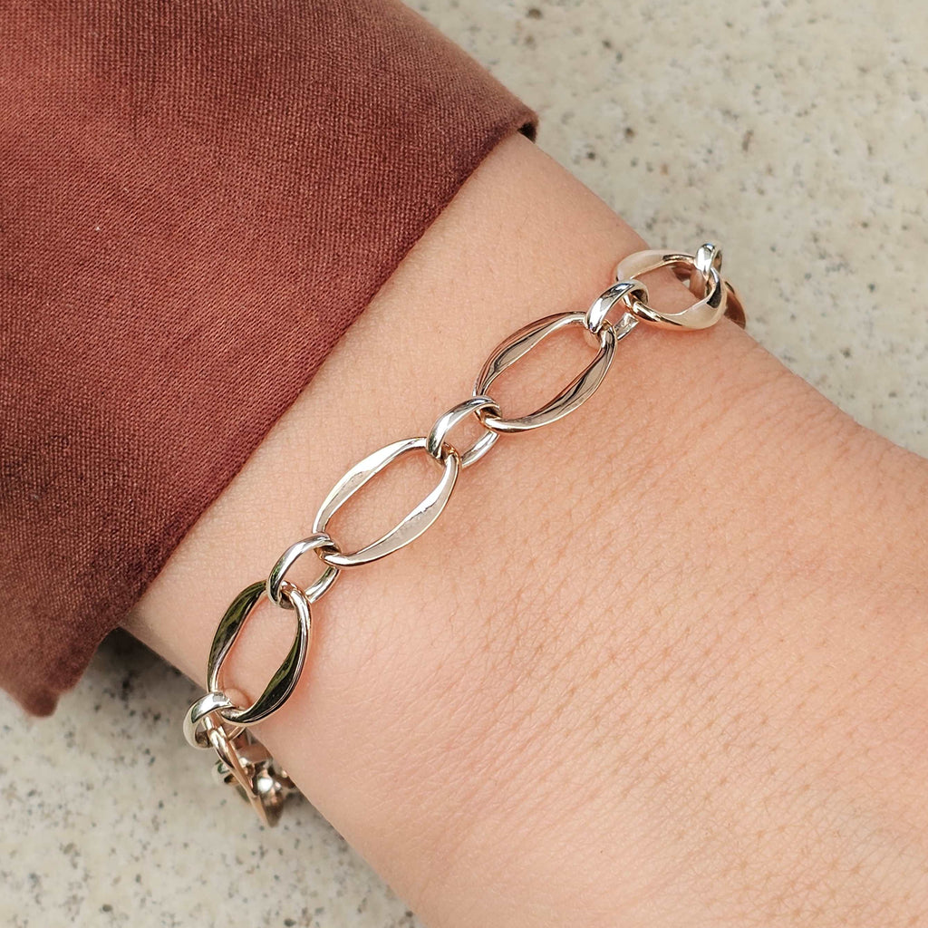 rose and white gold unique link bracelet on wrist