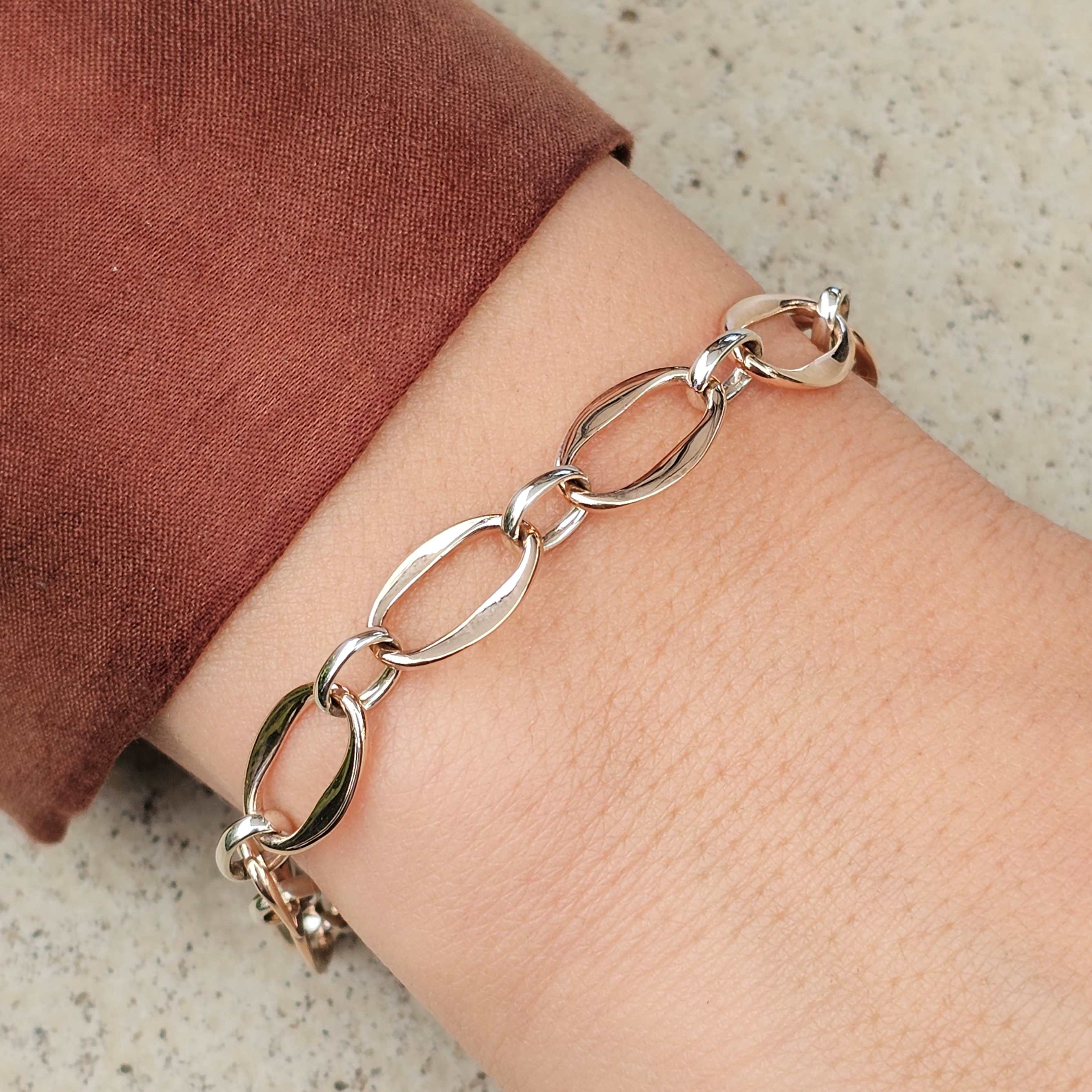 rose and white gold unique link bracelet on wrist