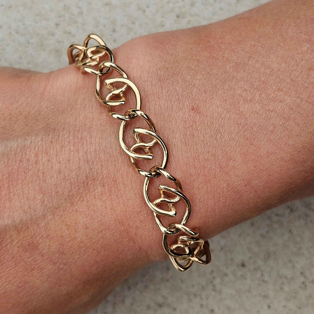 yellow gold unique twisted bracelet on wrist