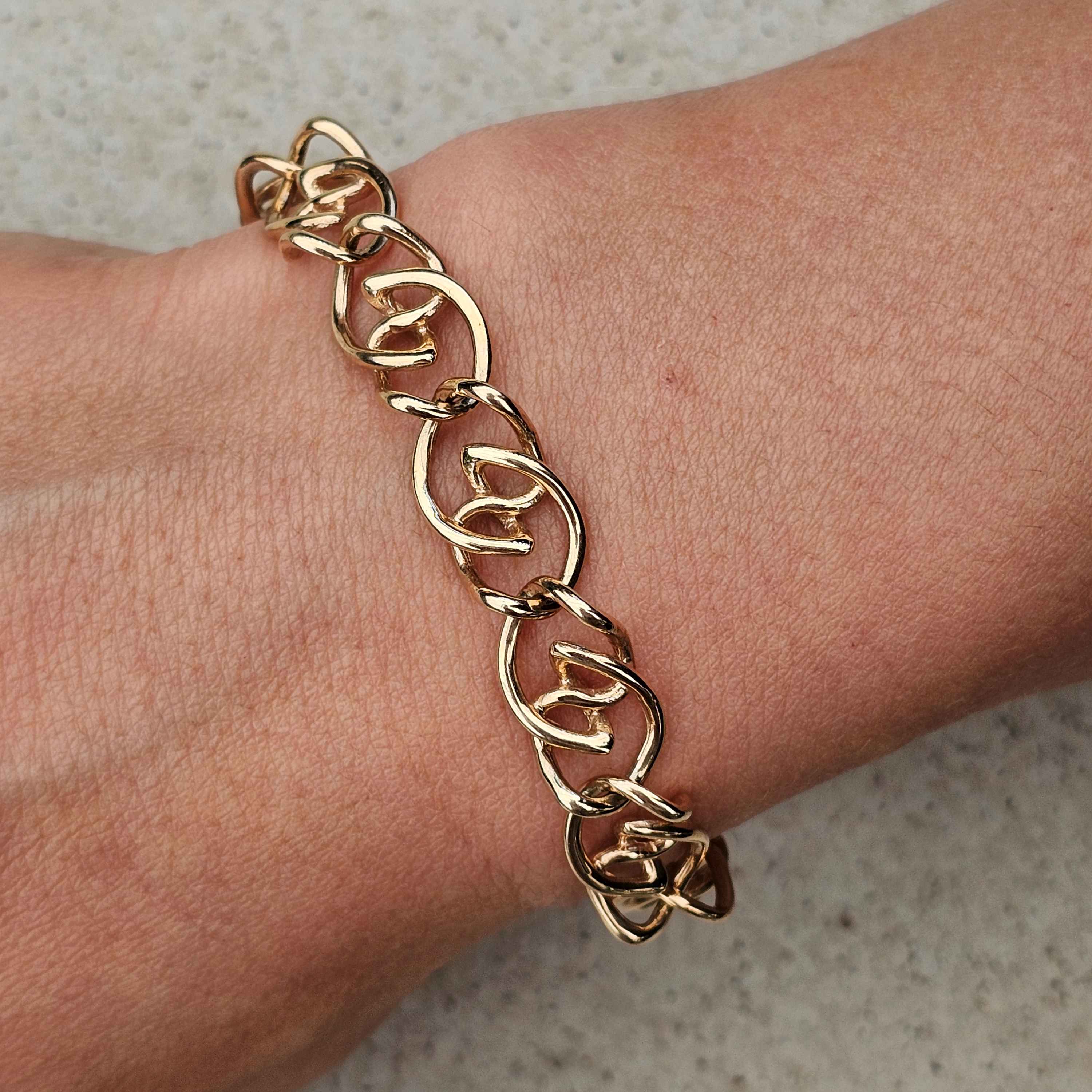 yellow gold unique twisted bracelet on wrist