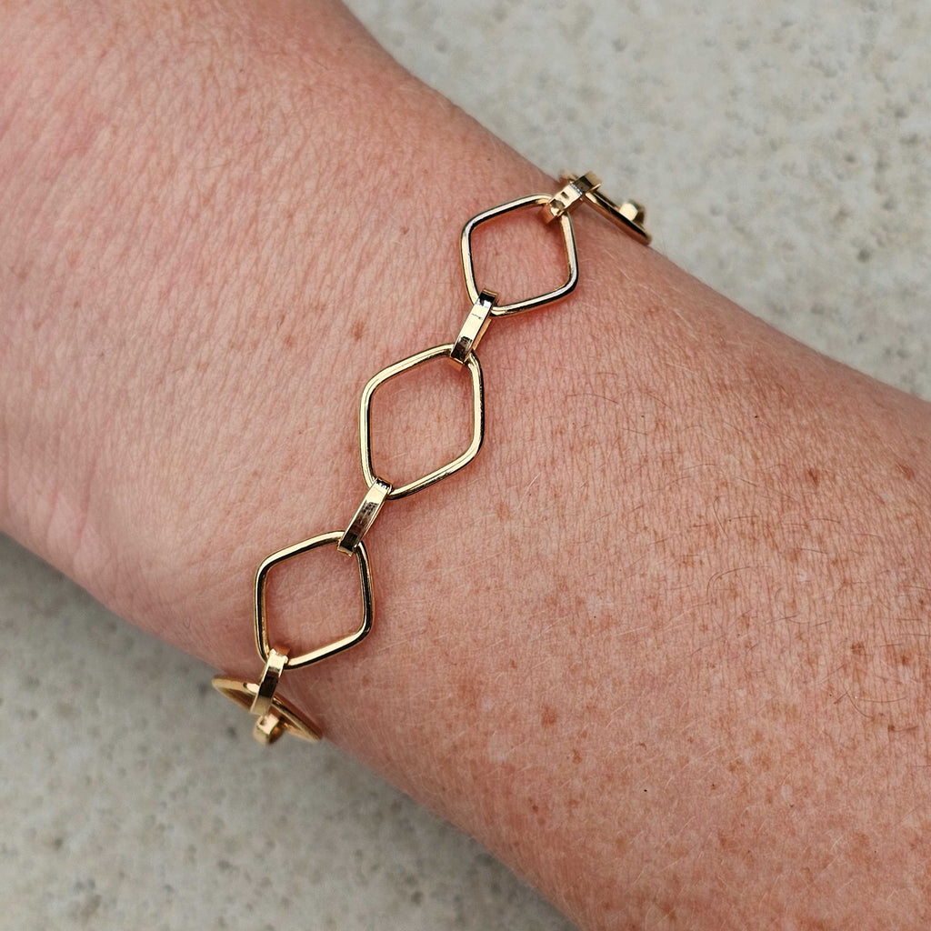 yellow gold unique diamond link bracelet on wrist