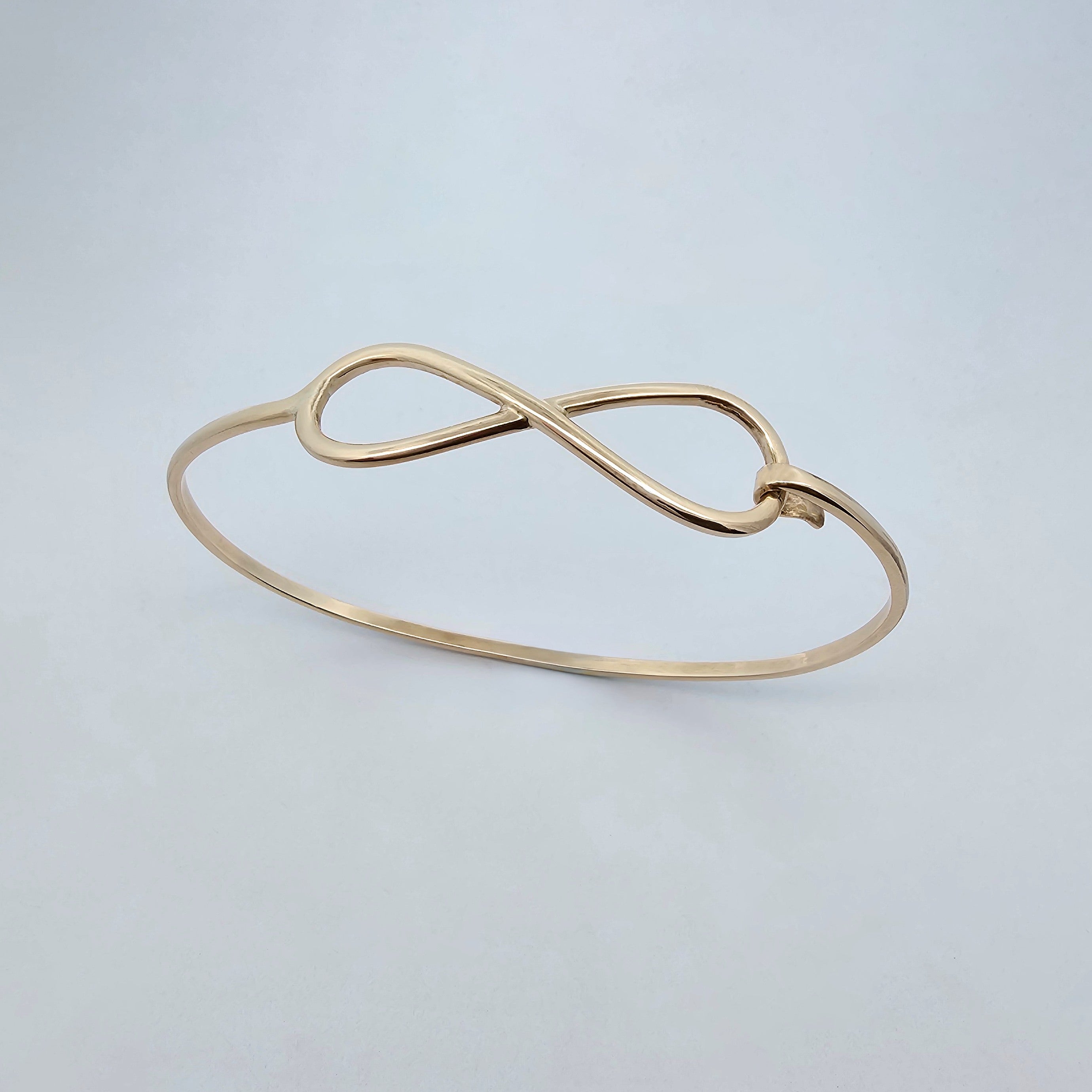 handcrafted yellow gold infinity bangle design 