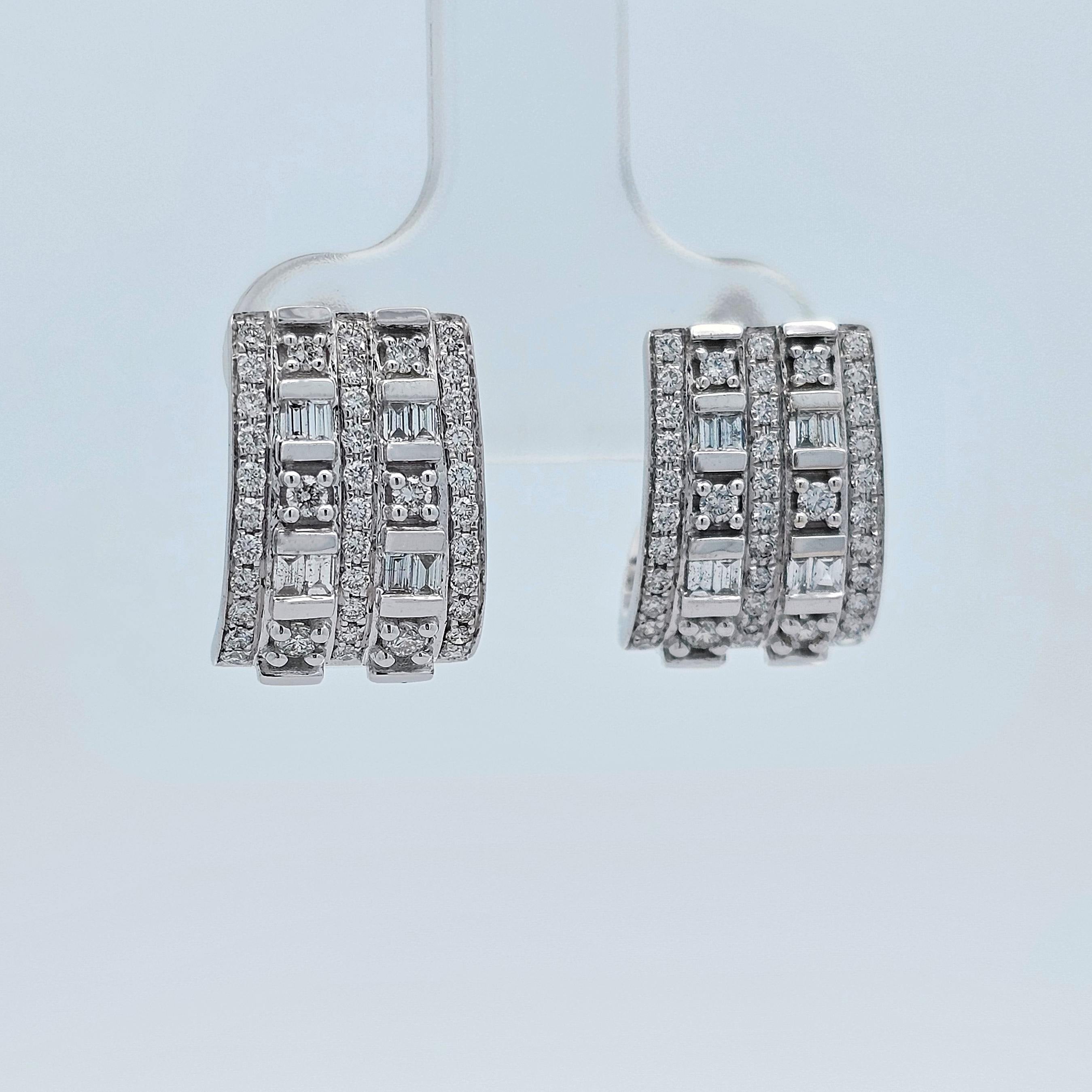 White gold huggie earrings set with rows of baguette and round diamonds in a bold, modern design.
