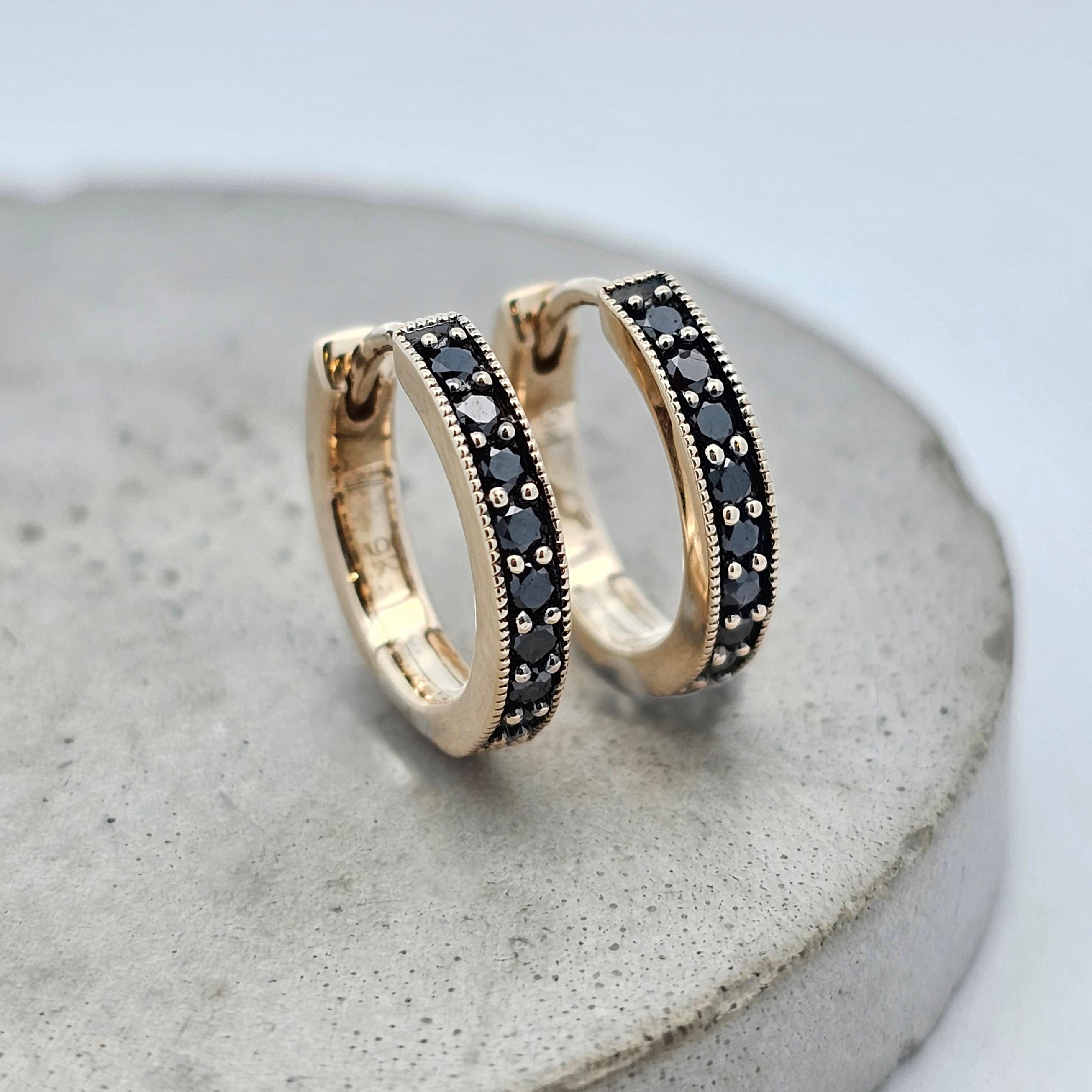 Yellow gold hoop earrings set with black diamonds, elegant and versatile design like the little black dress of jewellery.
