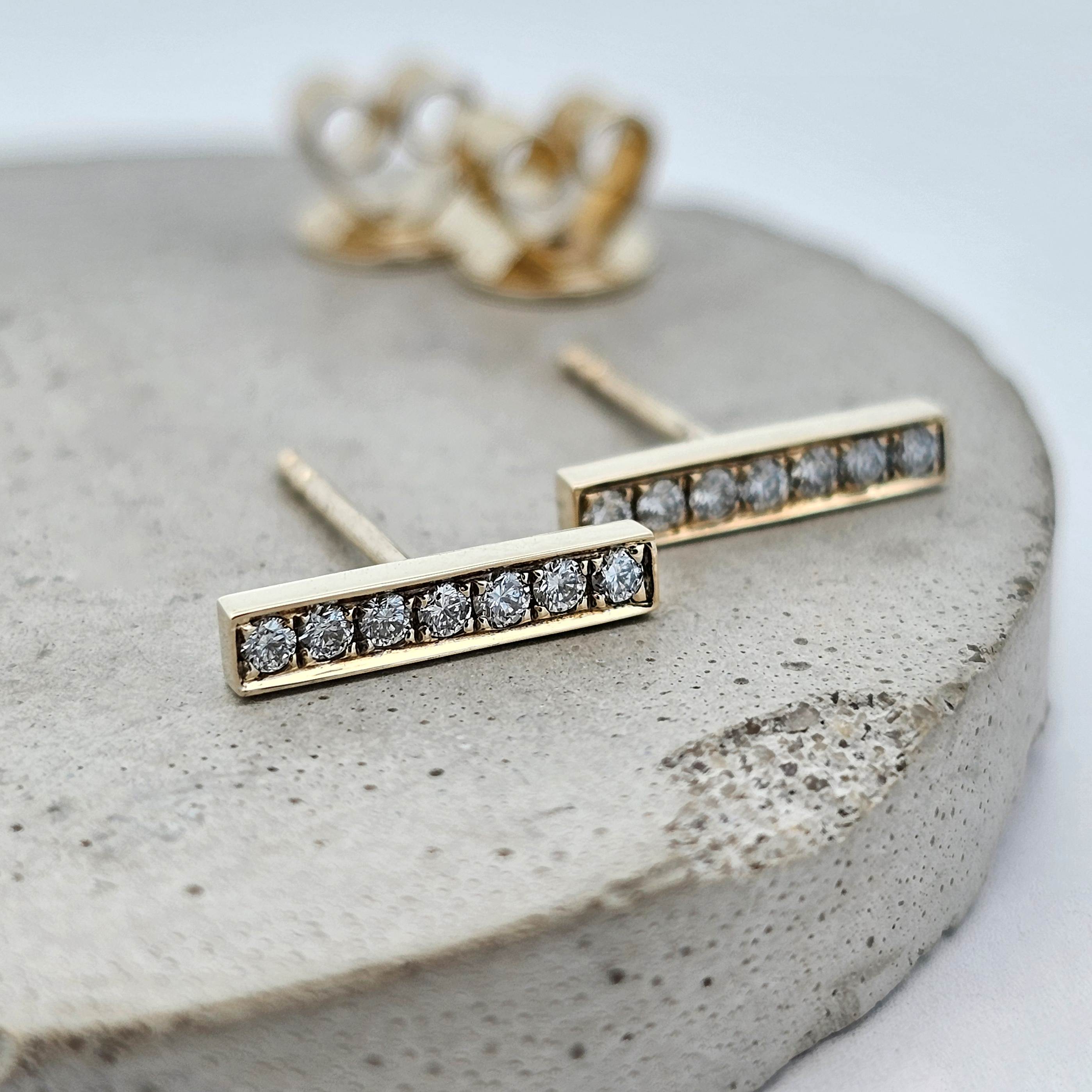9ct yellow gold modern bar stud earrings set with a row of round brilliant diamonds