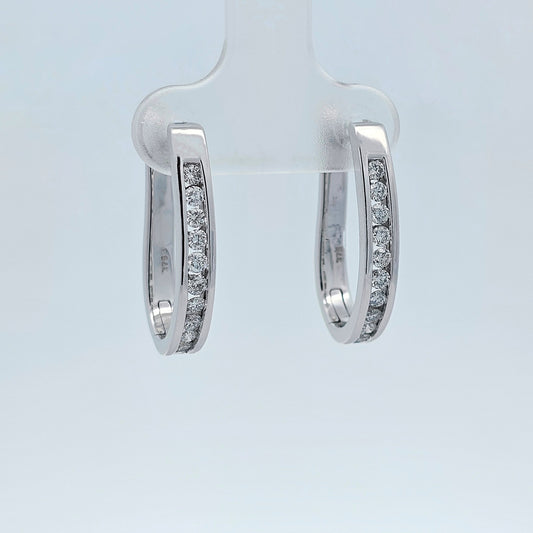 Pair of white gold diamond huggie earrings, channel-set with round brilliant diamonds in a sleek, curved design