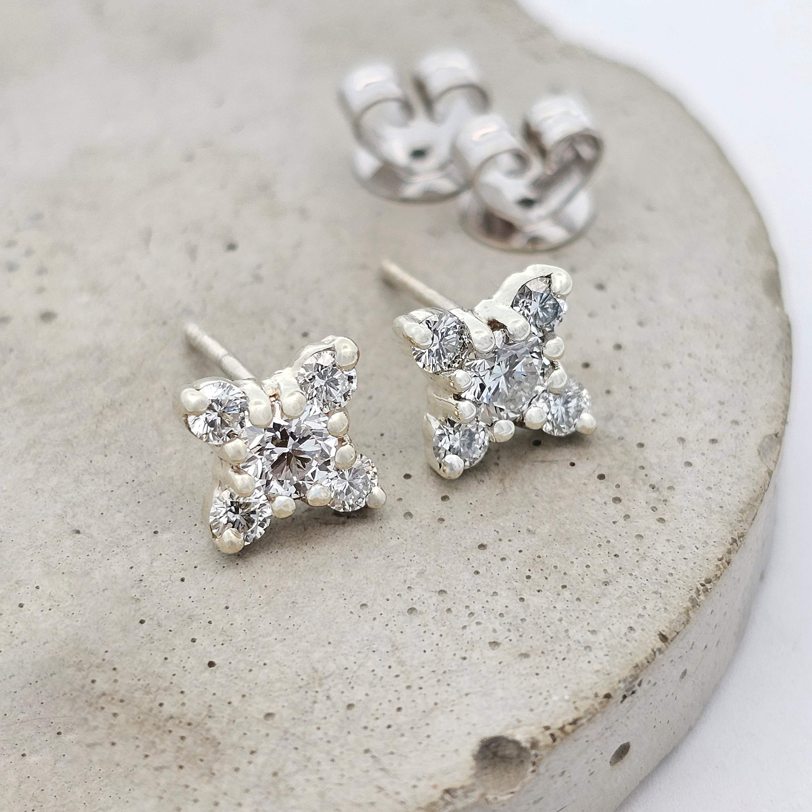 Snowflake diamond earrings in white gold, featuring brilliant-cut diamond clusters in a frosty stud design — elegant winter-inspired jewellery.