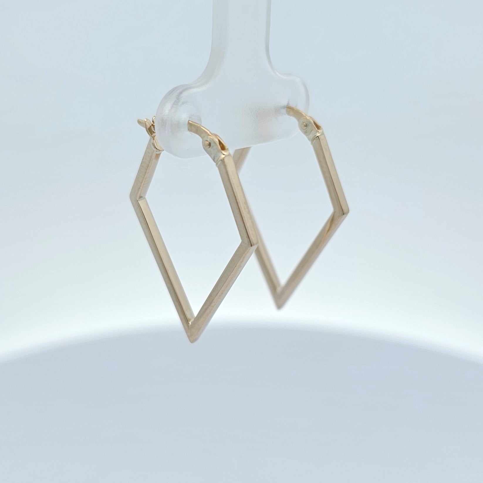 Geometric gold earrings with angular sculptural design and polished finish.