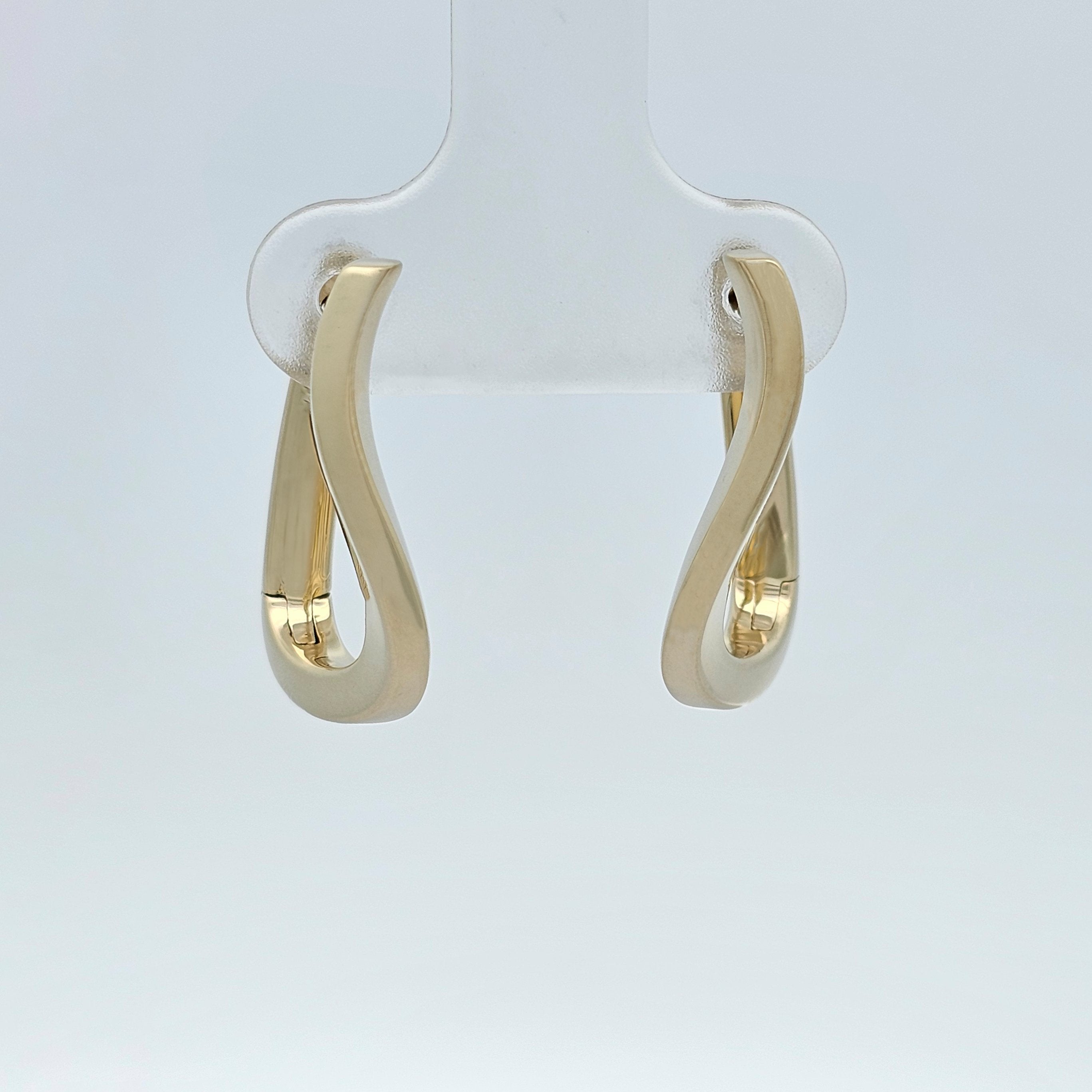 Yellow gold curved hoop earrings with a smooth flowing design