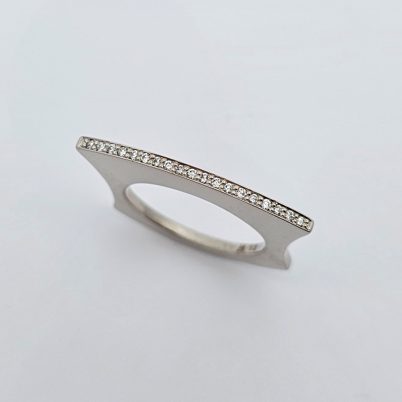 9ct white gold fan shaped ring with a fine line of bead set bright white diamonds.