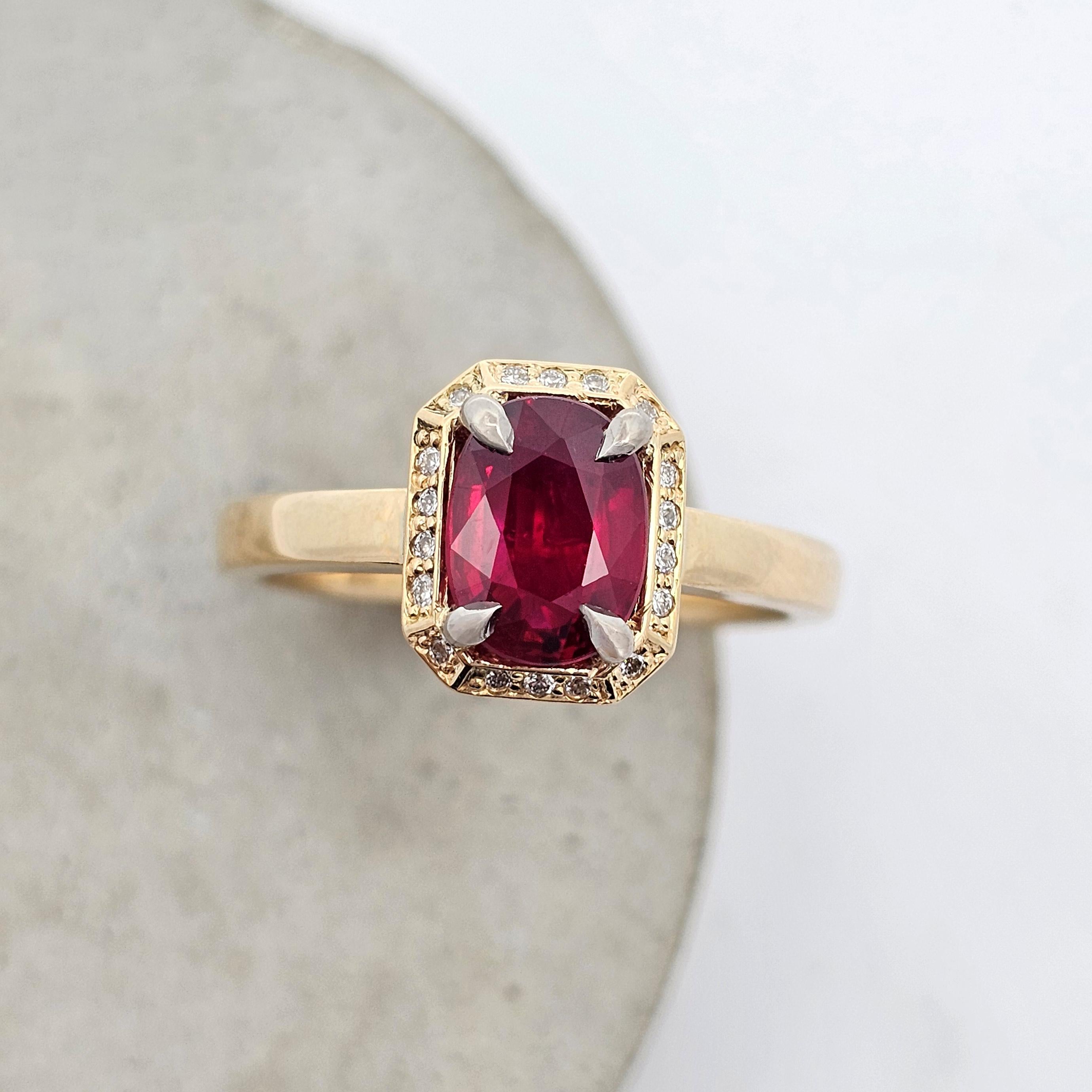 Yellow gold ring featuring an oval ruby set in an emerald-cut diamond halo with bold claw settings.