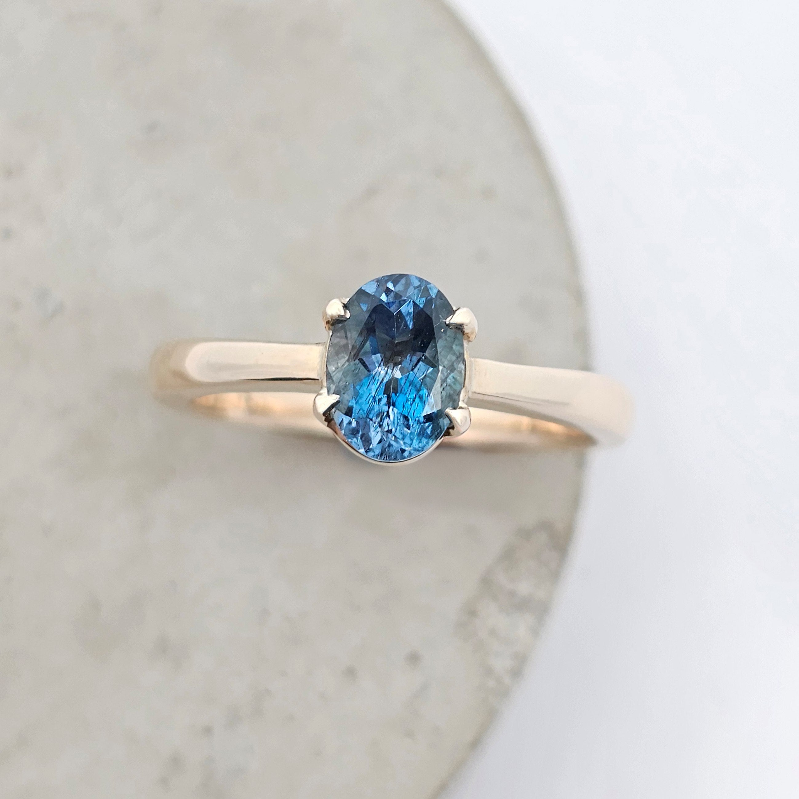 Aqua Serene oval natural aquamarine ring claw-set in yellow gold with a classic solitaire design.