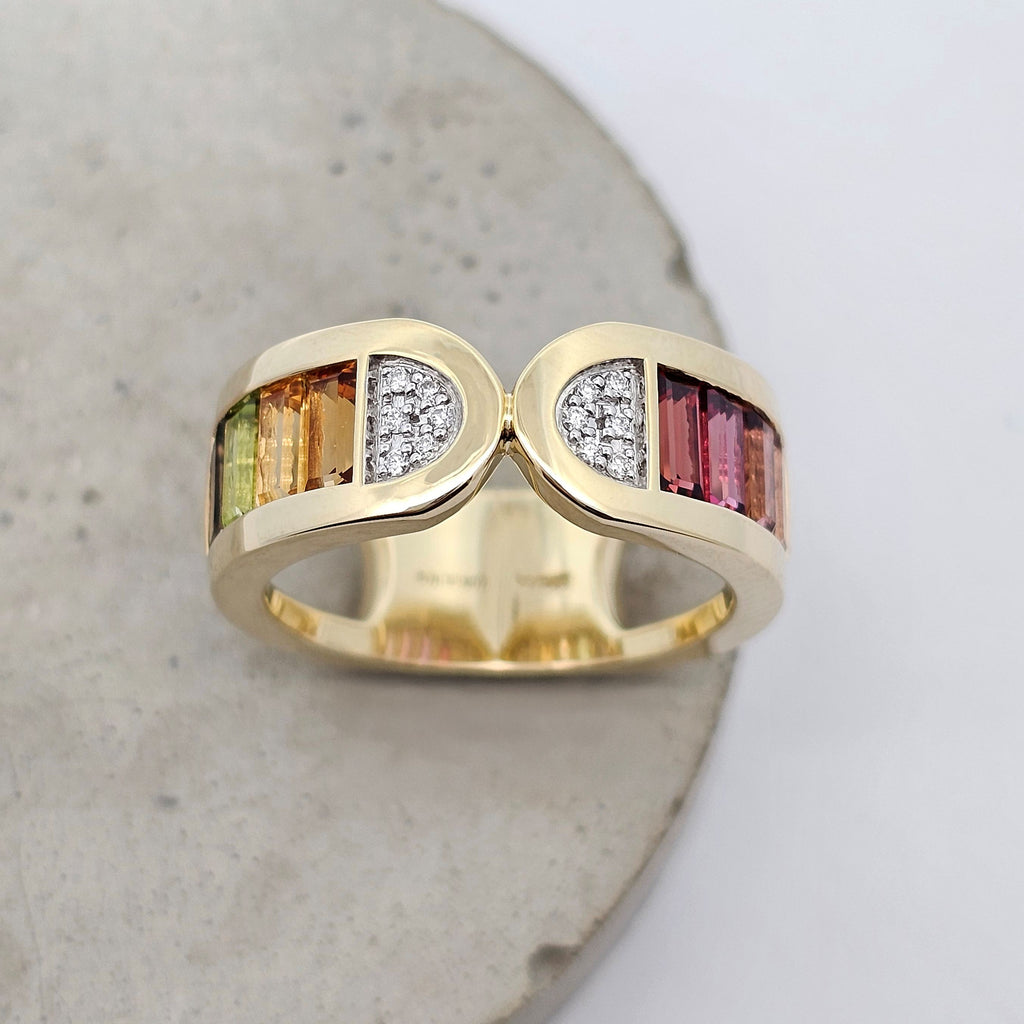 Colour Stack yellow gold ring with multicoloured baguette gemstones and natural diamond accents. Front View.
