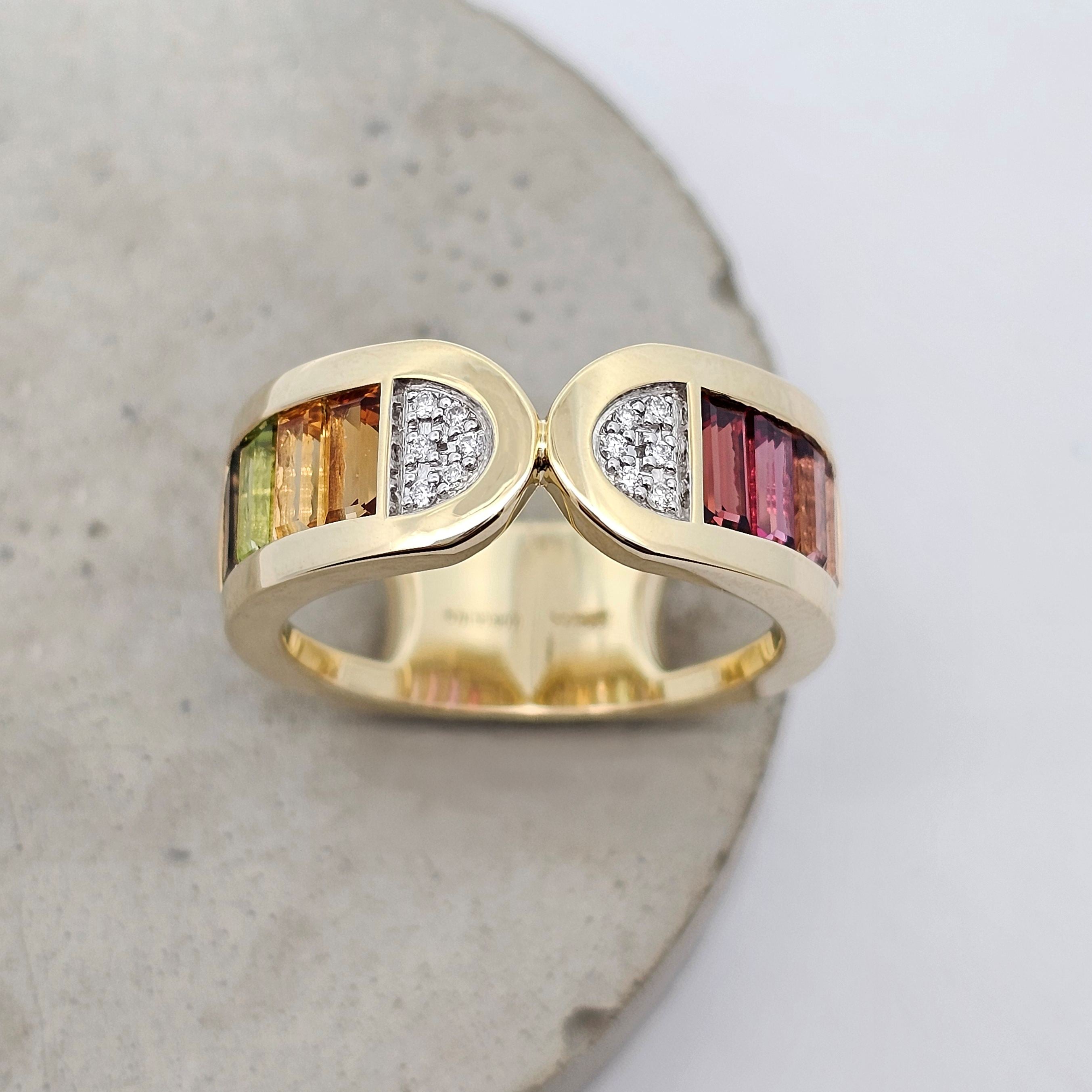 Colour Stack yellow gold ring with multicoloured baguette gemstones and natural diamond accents. Front View.
