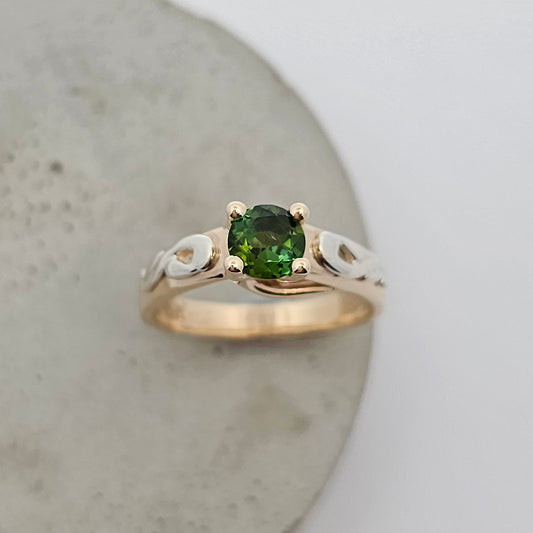 9ct yellow and white gold ladies coloured gemstone ring with a four claw set bright green round tourmaline and white gold shoulder details.