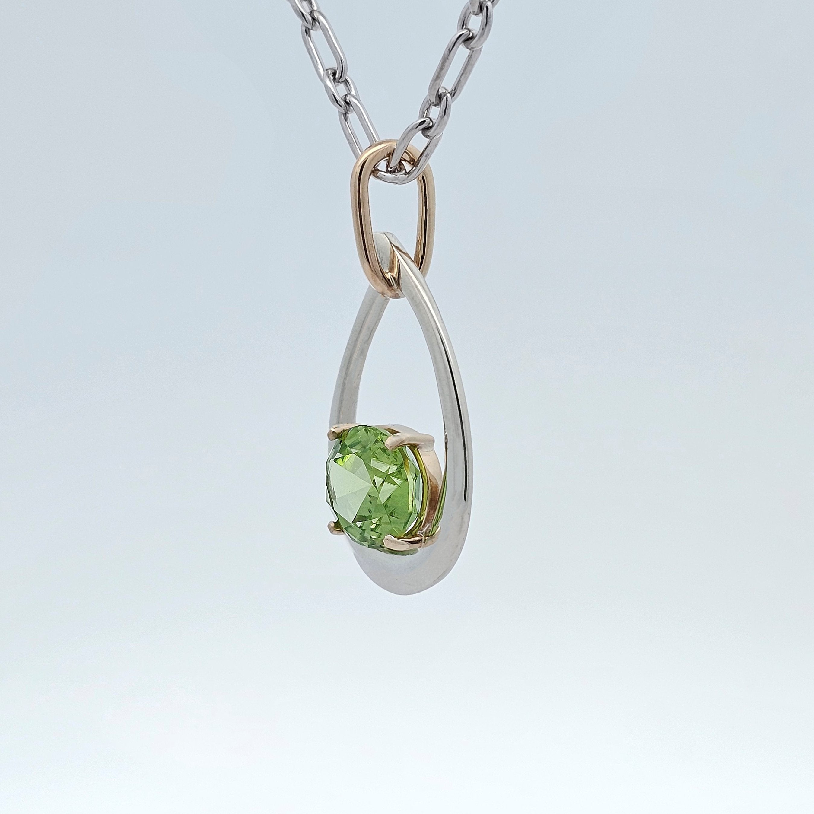 white and yellow gold two tone pendant featuring crisp apple green peridot from pakistan 