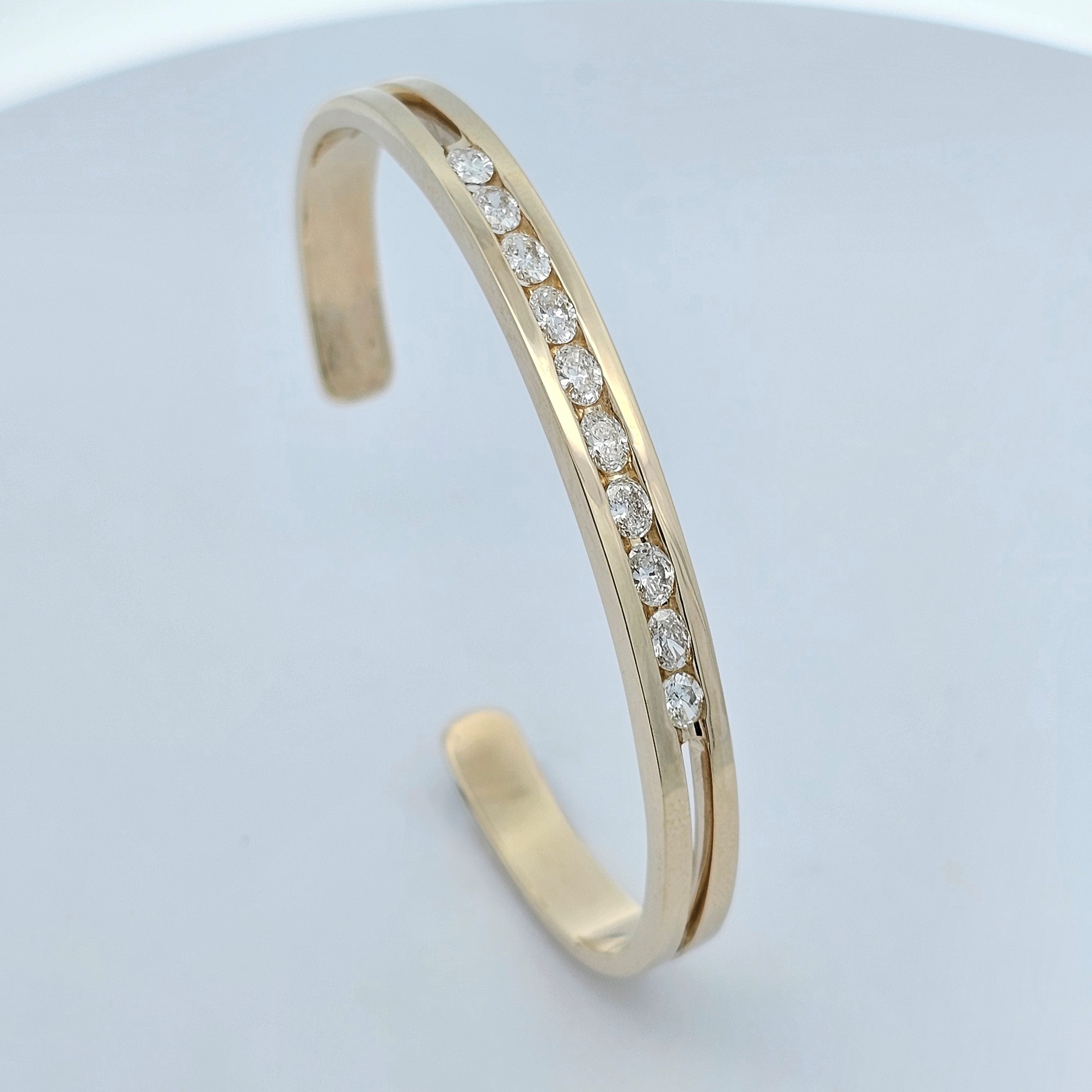yellow gold channel set one carat oval diamond fitted cuff bangle 